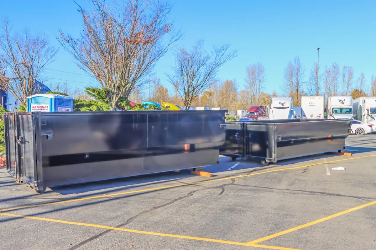 Professional dumpster rental service with roll-off container on residential driveway in Warsaw